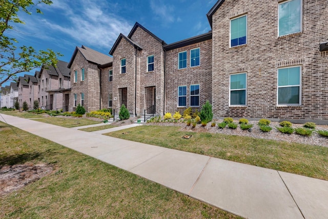 2812 Bluejack Rd, Mckinney, TX 75071 - view of front of house with a front lawn, brick siding, and a residential view