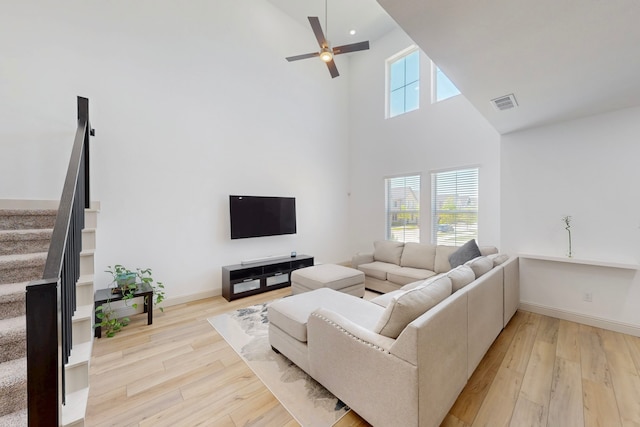 2812 Bluejack Rd, Mckinney, TX 75071 - living area featuring high vaulted ceiling, stairway, light wood-style flooring, and ceiling fan