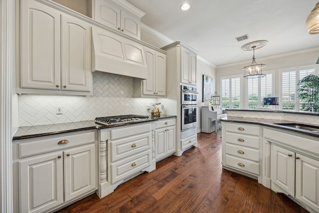 1318 Amsterdam Ct, Granbury, TX 76048 - kitchen with stainless steel appliances, dark countertops, crown molding, a sink, and backsplash