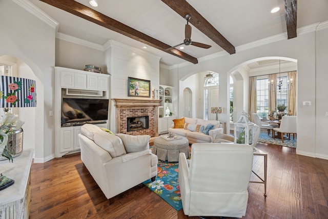 1318 Amsterdam Ct, Granbury, TX 76048 - living room with ceiling fan, a fireplace, beamed ceiling, arched walkways, and dark wood finished floors