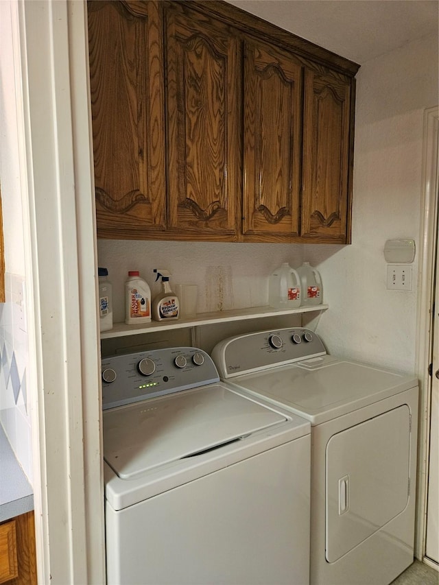 clothes washing area with cabinet space and washing machine and clothes dryer