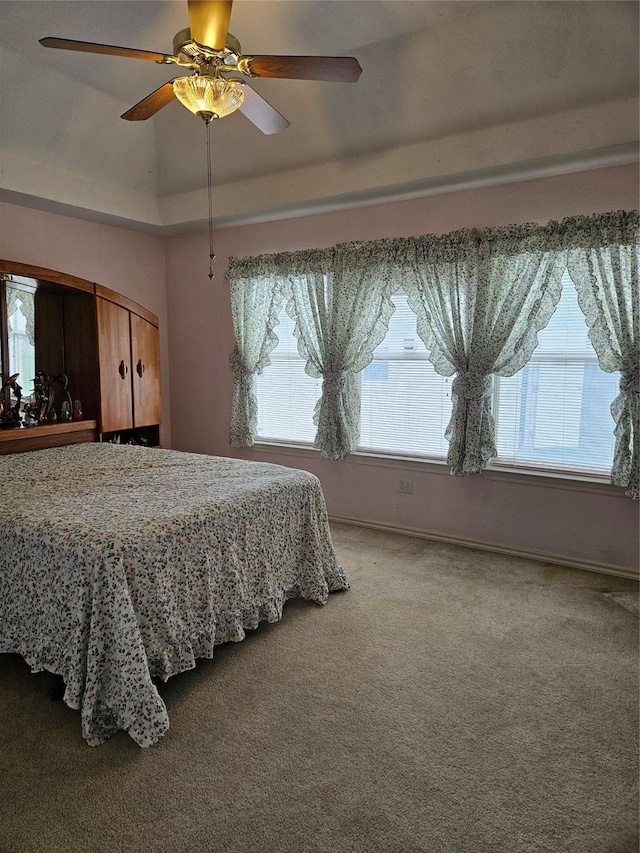 carpeted bedroom featuring baseboards and ceiling fan