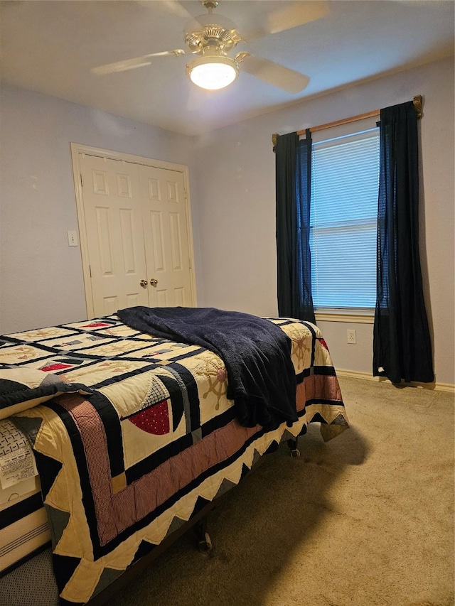 carpeted bedroom with a closet and a ceiling fan