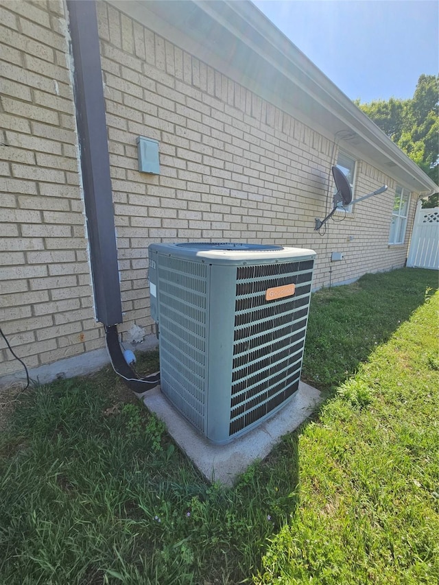 exterior details with brick siding and cooling unit