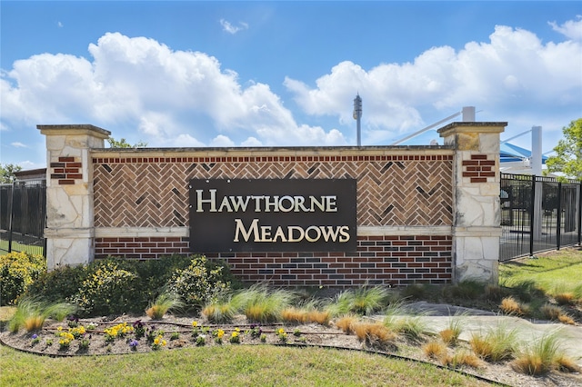community sign featuring fence