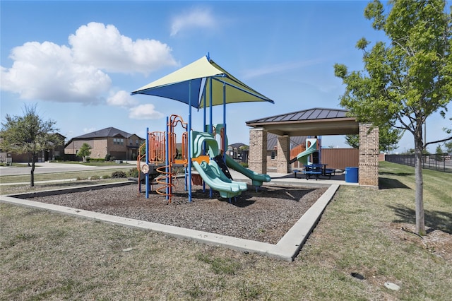 communal playground with fence and a lawn