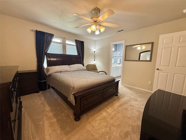 bedroom with connected bathroom, ceiling fan, light colored carpet, baseboards, and visible vents