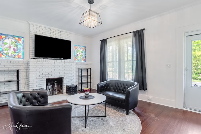 living room featuring baseboards, wood finished floors, a brick fireplace, and ornamental molding
