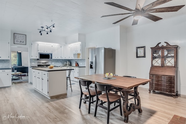 dining area featuring ceiling fan and light wood-style floors