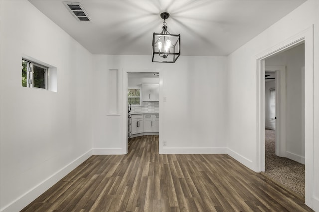 1507 Newport Ave, Dallas, TX 75224 - unfurnished dining area featuring baseboards, visible vents, an inviting chandelier, and dark wood-style floors