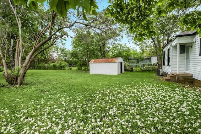 1507 Newport Ave, Dallas, TX 75224 - view of yard with a fenced backyard, an outdoor structure, a storage shed, and central AC unit