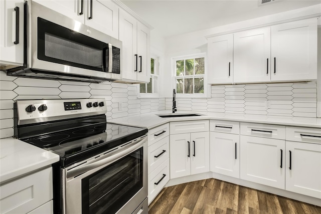 1507 Newport Ave, Dallas, TX 75224 - kitchen with tasteful backsplash, a sink, stainless steel appliances, light countertops, and white cabinetry