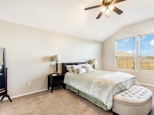 bedroom featuring baseboards, lofted ceiling, ceiling fan, and light carpet
