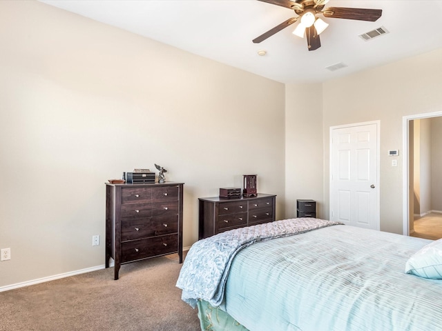 carpeted bedroom featuring baseboards, a ceiling fan, and visible vents