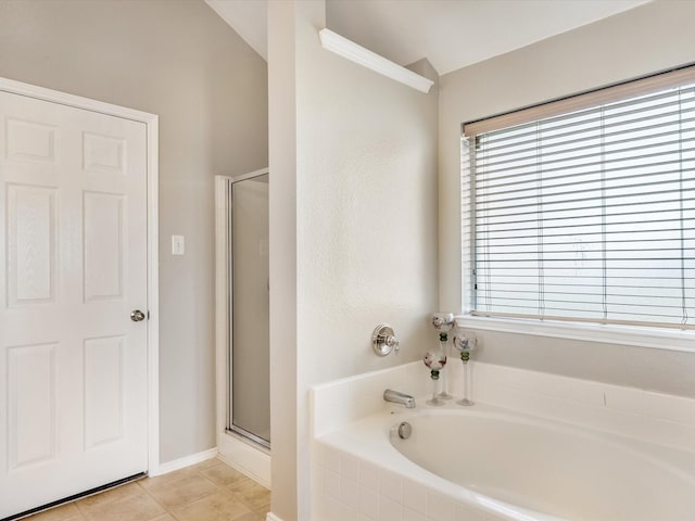 full bathroom with a bath, tile patterned floors, a shower stall, and plenty of natural light