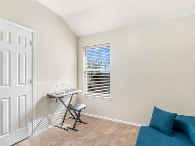 interior space featuring vaulted ceiling and baseboards