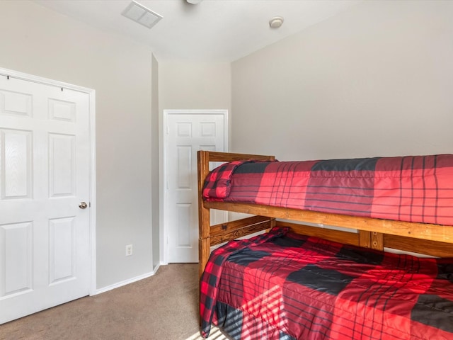 carpeted bedroom with visible vents and baseboards