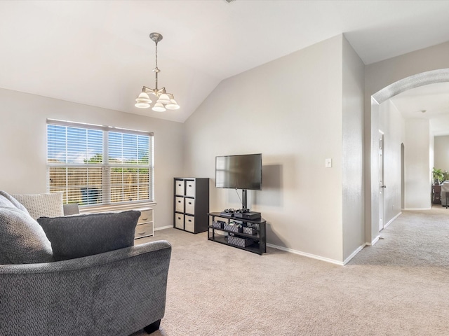 carpeted living area featuring arched walkways, a chandelier, lofted ceiling, and baseboards