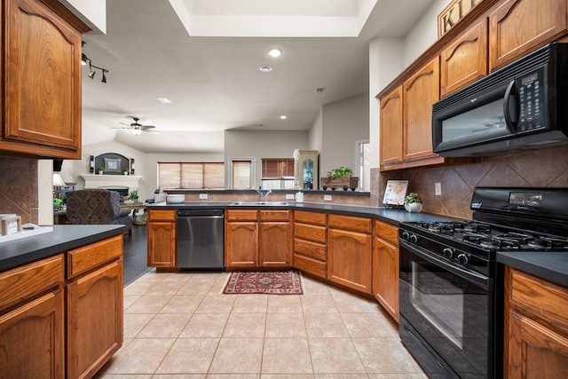 2833 Spotted Owl Dr, Fort Worth, TX 76244 - kitchen featuring black appliances, a sink, dark countertops, decorative backsplash, and brown cabinetry