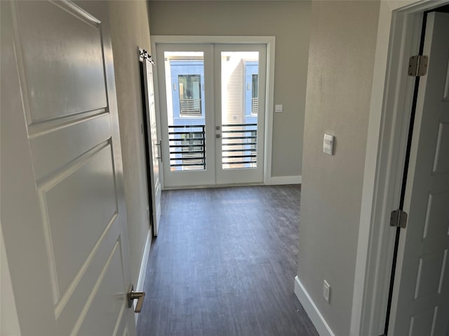 hall featuring wood finished floors, french doors, and baseboards