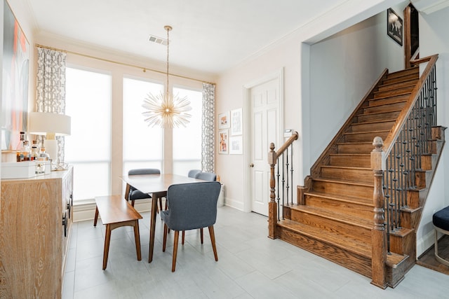 dining area featuring baseboards, visible vents, a chandelier, stairway, and ornamental molding