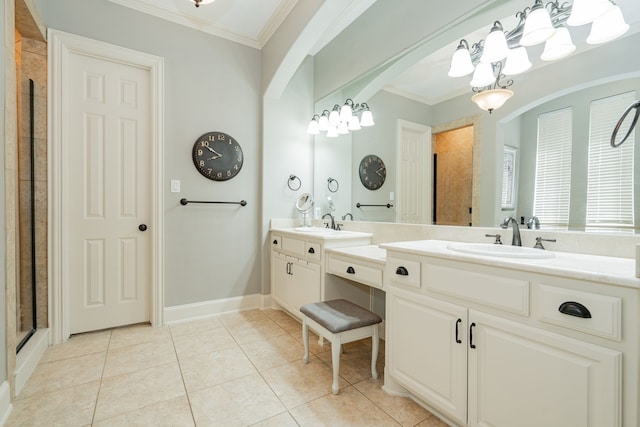 bathroom featuring a tile shower, crown molding, a chandelier, and a sink
