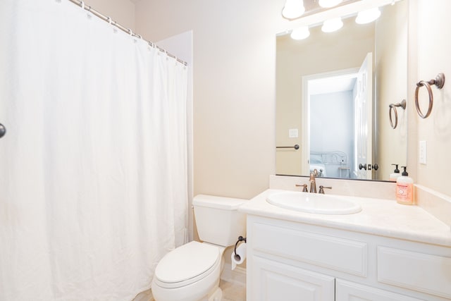 full bath featuring connected bathroom, toilet, and vanity
