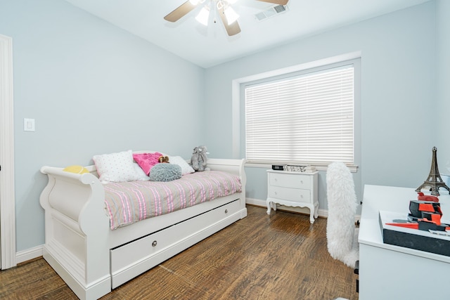 bedroom with wood finished floors, visible vents, baseboards, and ceiling fan
