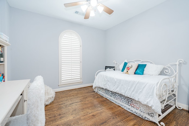 bedroom with wood finished floors, a ceiling fan, and baseboards