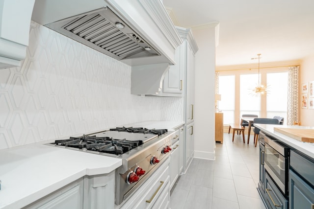 kitchen with white cabinetry, backsplash, custom range hood, light countertops, and appliances with stainless steel finishes