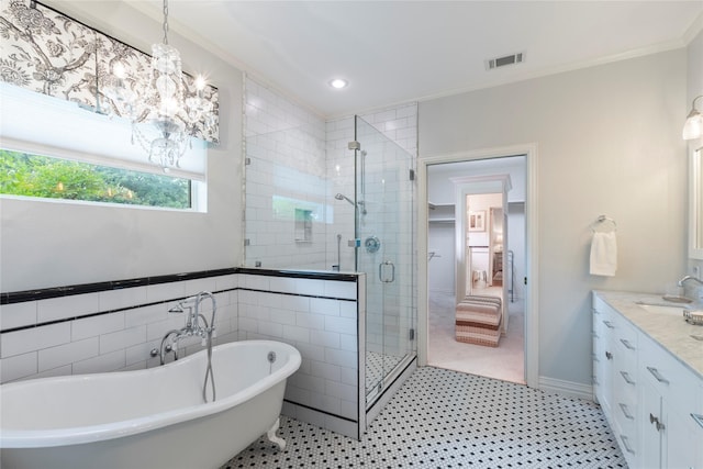 bathroom with a stall shower, vanity, a freestanding bath, ornamental molding, and visible vents