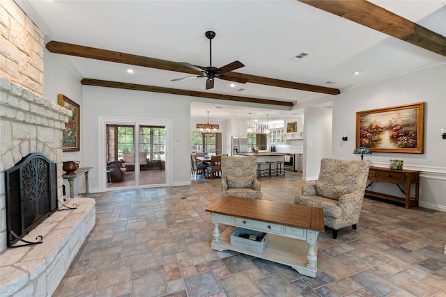 125 Bay Tree Trl, Mabank, TX 75156 - living area with stone finish floors, a chandelier, a ceiling fan, beamed ceiling, and recessed lighting