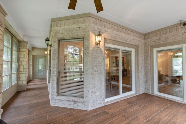 doorway to property featuring a ceiling fan and covered porch