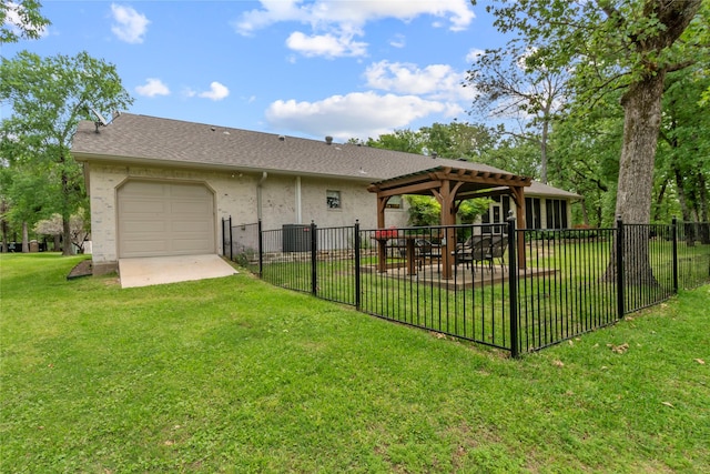 rear view of house featuring a lawn, fence, stucco siding, and a garage