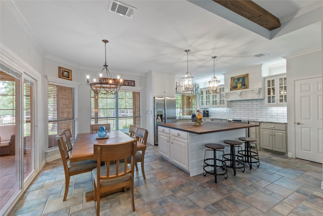 kitchen with stone tile floors, a chandelier, wooden counters, and stainless steel fridge with ice dispenser