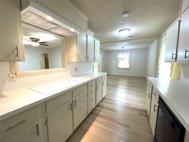 kitchen featuring white electric stovetop, light wood-type flooring, black dishwasher, wall chimney range hood, and light countertops