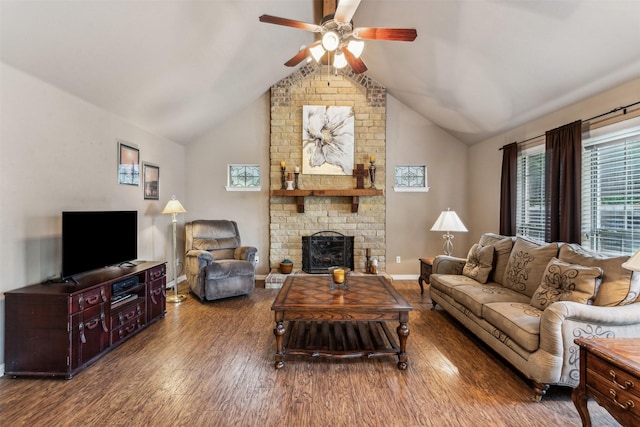 living room with wood finished floors, a brick fireplace, lofted ceiling, and ceiling fan