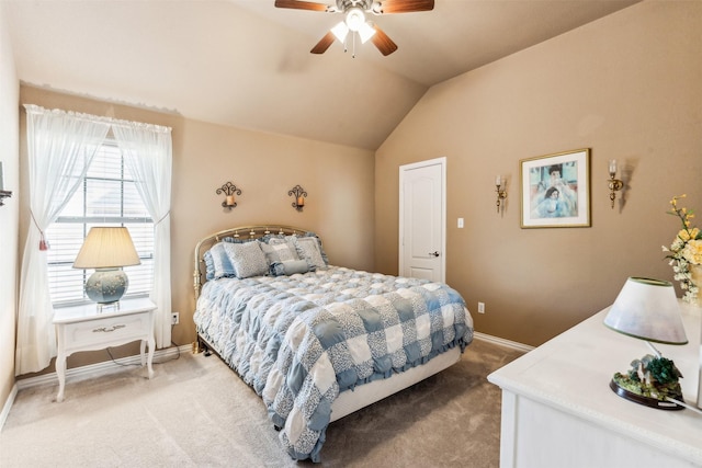 bedroom featuring ceiling fan, vaulted ceiling, baseboards, and light carpet