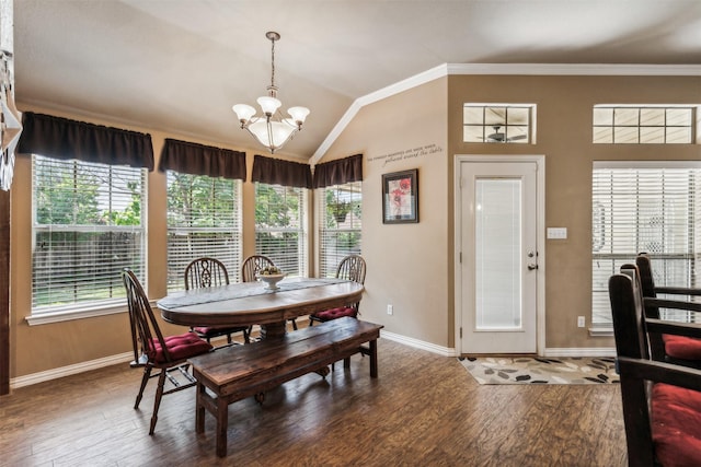 dining room with a chandelier, wood finished floors, lofted ceiling, and ornamental molding