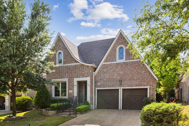 904 Chapel Hill Ln, Mckinney, TX 75069 - tudor house with brick siding, driveway, a garage, and a front lawn