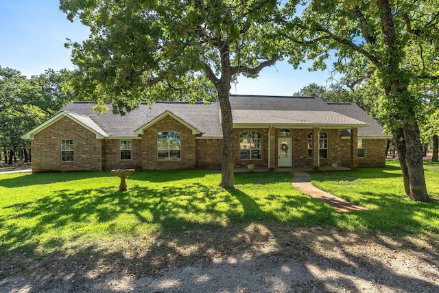 6424 County Road 176, Stephenville, TX 76401 - ranch-style home featuring brick siding, a shingled roof, and a front yard