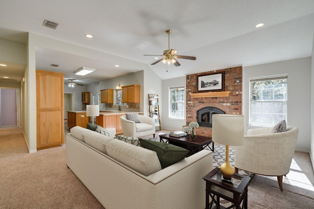 6424 County Road 176, Stephenville, TX 76401 - living area with visible vents, a ceiling fan, light carpet, baseboards, and a fireplace