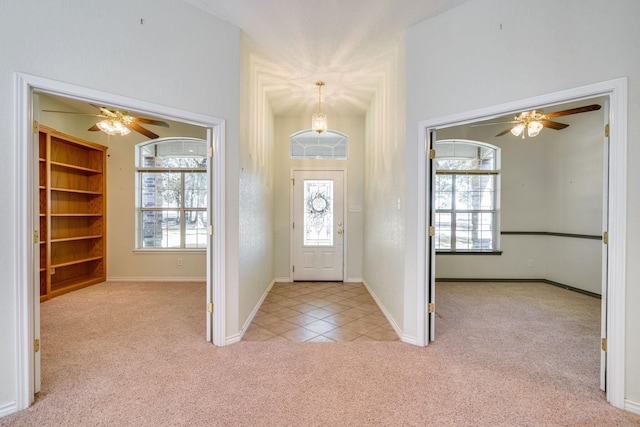 6424 County Road 176, Stephenville, TX 76401 - entrance foyer featuring a ceiling fan, baseboards, light colored carpet, and a healthy amount of sunlight