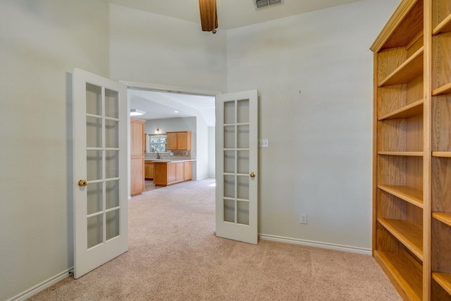 6424 County Road 176, Stephenville, TX 76401 - spare room featuring visible vents, a sink, french doors, baseboards, and light colored carpet