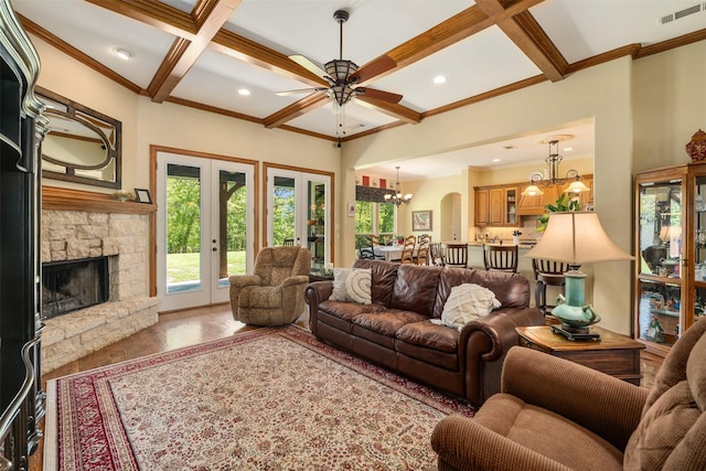 living area with coffered ceiling, wood finished floors, visible vents, and ceiling fan with notable chandelier