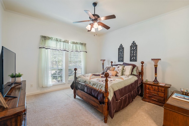 bedroom with ceiling fan, light colored carpet, and ornamental molding