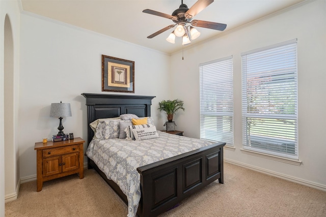 bedroom with light carpet, baseboards, and ornamental molding