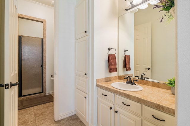 full bath featuring crown molding, vanity, tile patterned floors, and a stall shower