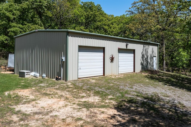 detached garage with a wooded view