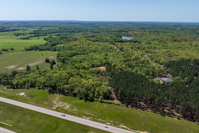 bird's eye view featuring a wooded view